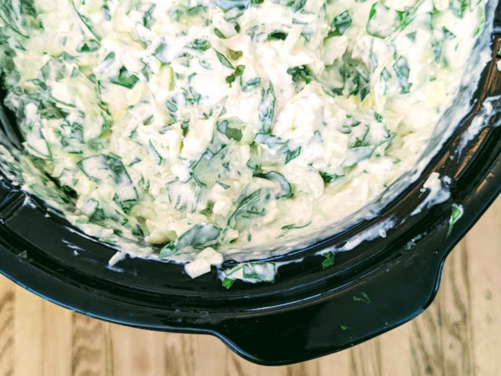 Creamy spinach artichoke dip in a slow cooker. Perfect for game day or parties. 